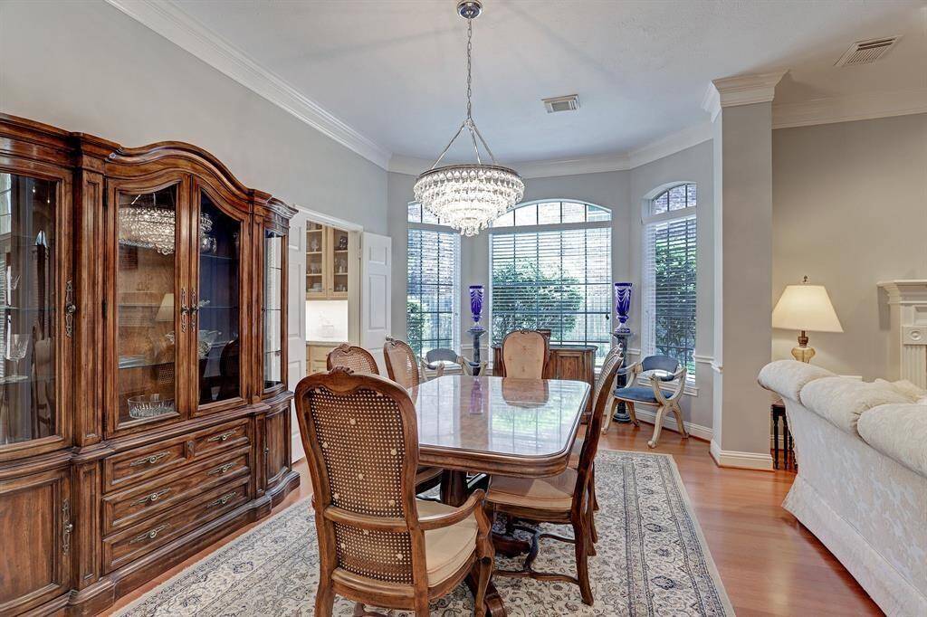 The formal living space looking from the entryway. Features such as the crown molding and the recessed lighting highlight this beautiful home.