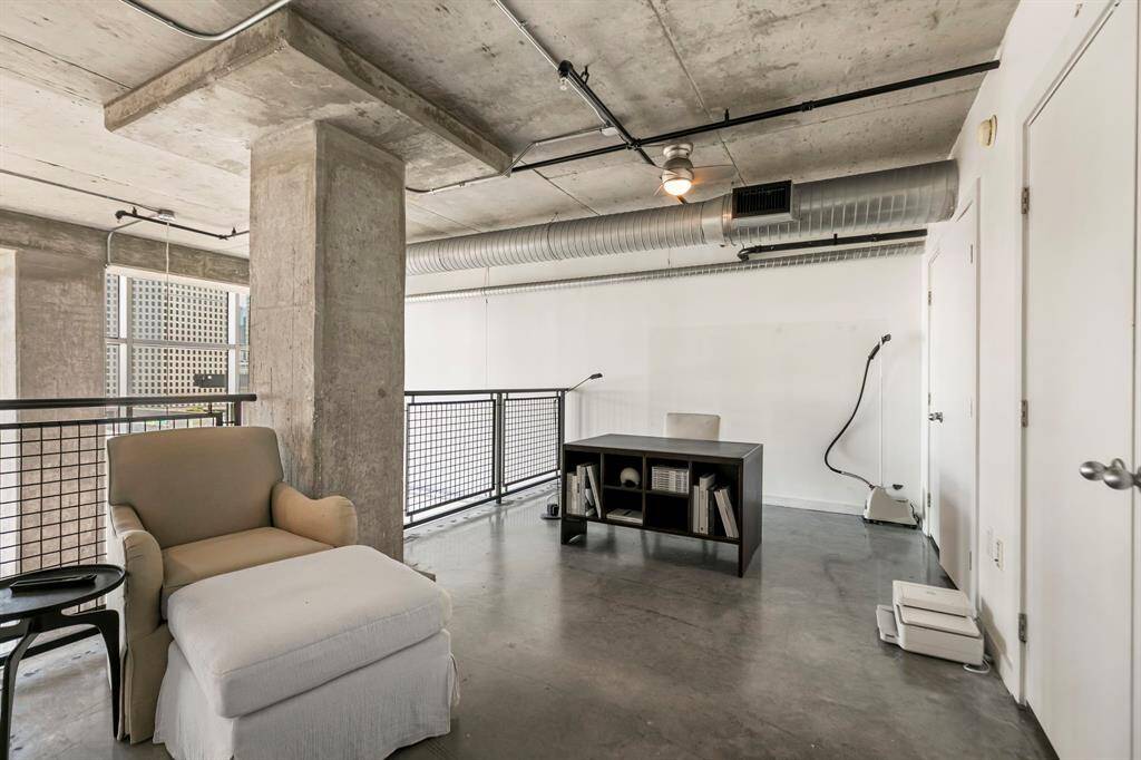 2nd floor loft area has concrete flooring and lots of natural lights.  Doors open to full size Washer & Dryer and also another large closet perfect for storage.
