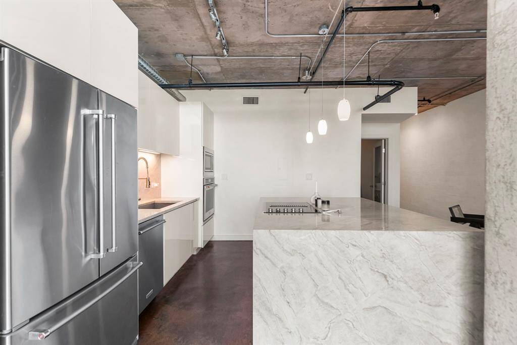 You will love cooking in this designer kitchen with all the sleek updates. KitchenAid SS appliances, modern sink and faucets, and pendent lighting.