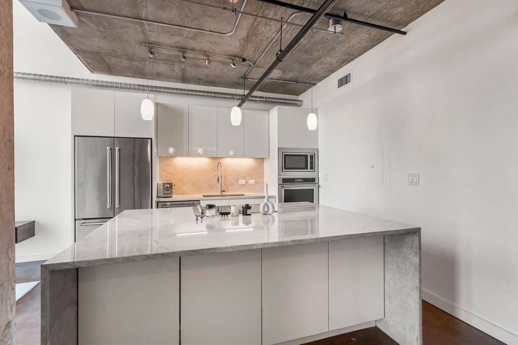 Notice all of the storage in this light and bright kitchen. Island features storage on BOTH sides!
