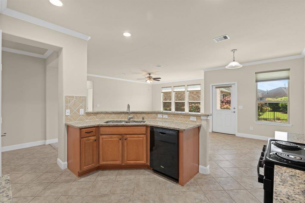 From the kitchen, take in the serene view of your private backyard—perfect for moments of peace or entertaining guests!