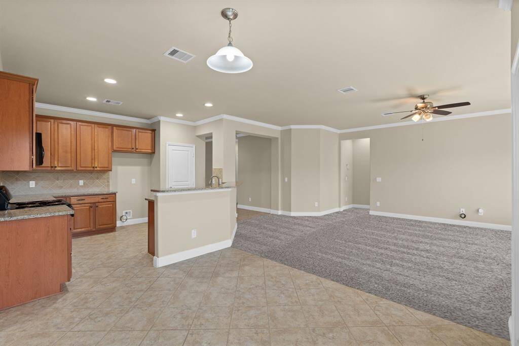 The primary bedroom features three large windows that offer both privacy and plenty of natural light—perfect for letting in the sunshine when you want to keep the window treatments open!