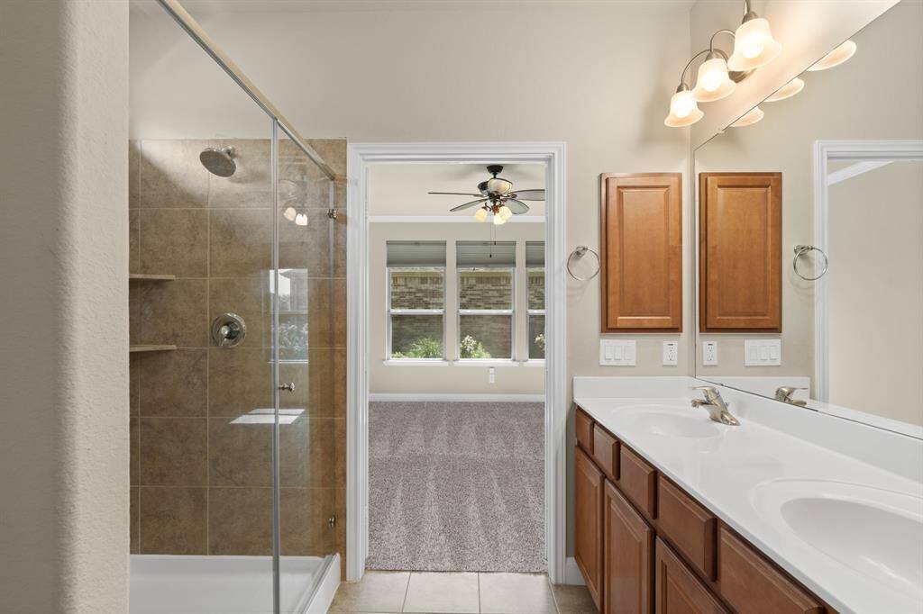 Relax and unwind in the walk-in shower, featuring a built-in bench for added comfort and convenience.