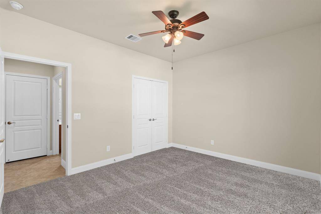 The spacious laundry room boasts ample counter space, plenty of cabinets for storage, and a handy sink for added convenience.
