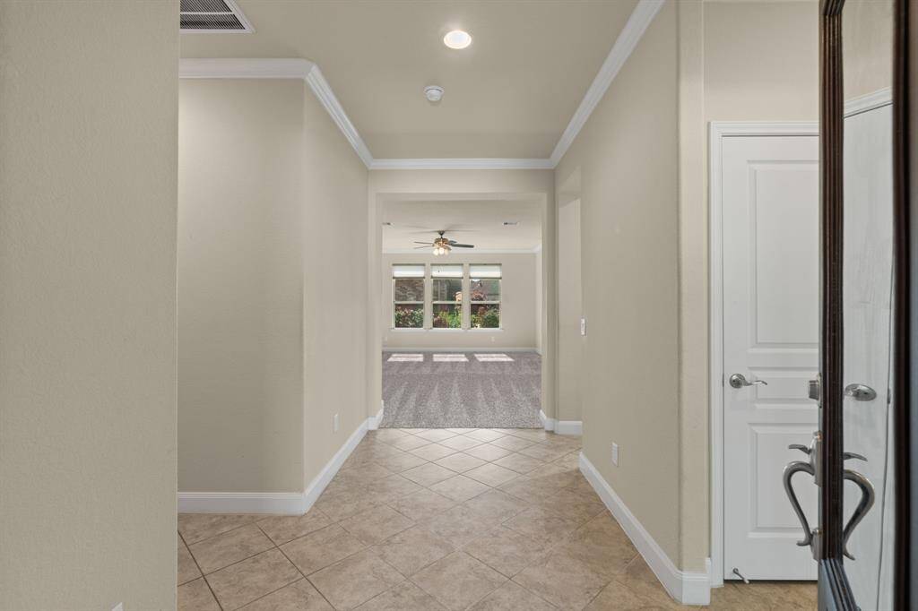 Step into a bright foyer featuring diagonally laid 12x12 tile for a stylish touch. Crisp 3¼” baseboards and elegant crown molding add just the right amount of polish to this welcoming entryway.