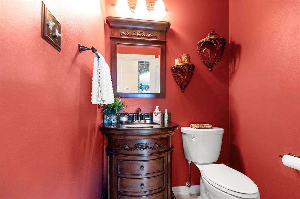 Warm Powder Room with the Mirror and Fixtures Featured.