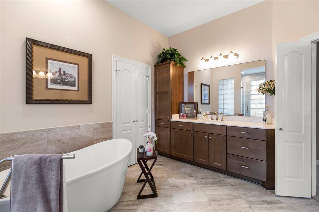 Beautiful Fixtures and Countertops with Built-in Cabinet in Primary Bathroom