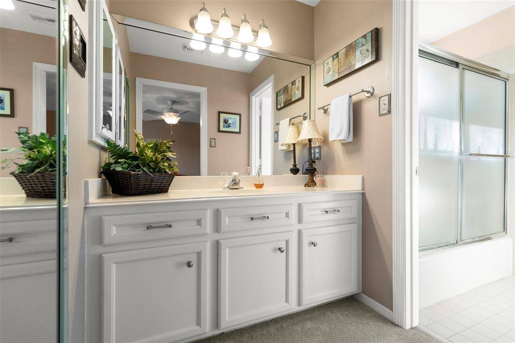 Modern Bath with Cabinets and a Sliding Door Shower/Tub Combo