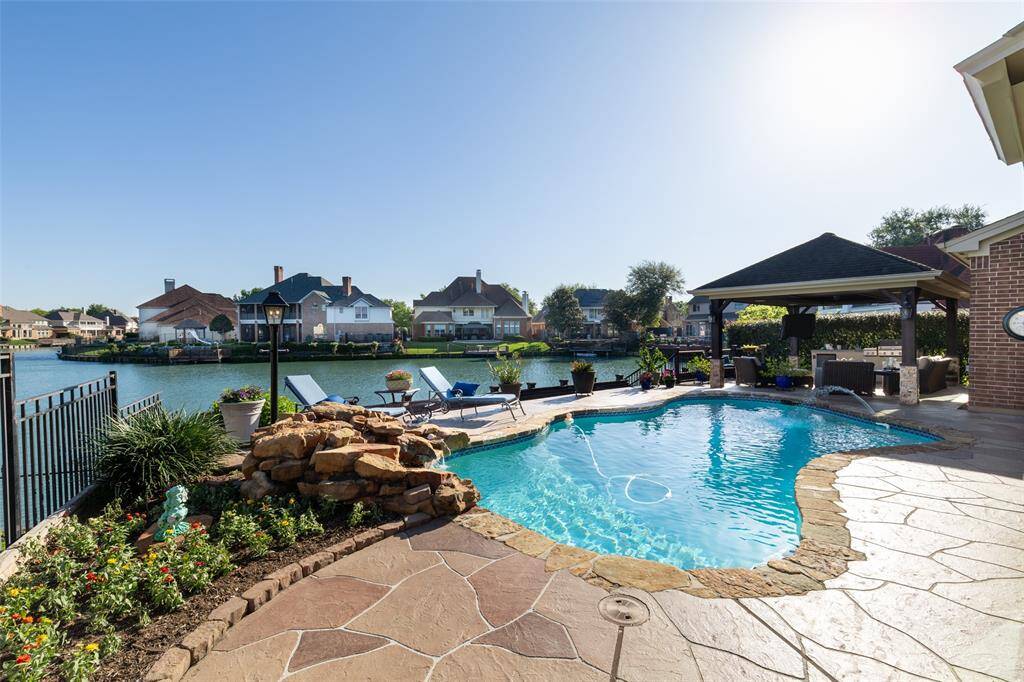 This Backyard Oasis Features a Spacious Pool with a Stylish Border