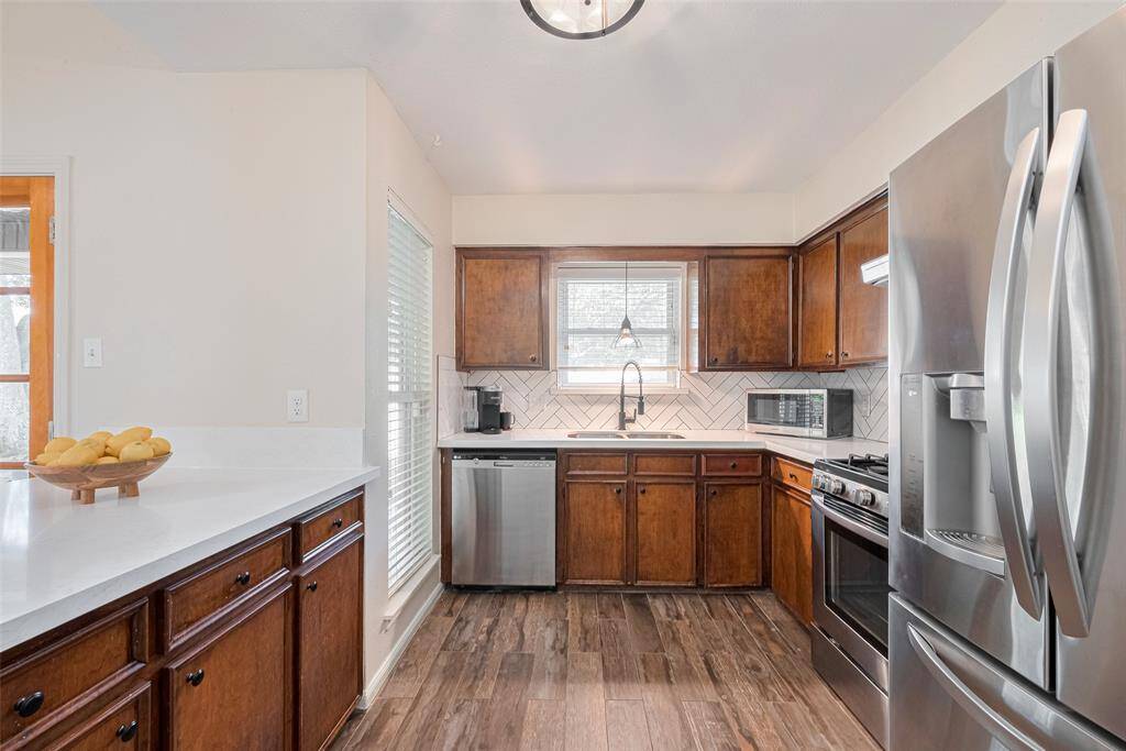 Stainless steel appliances, Quartz Counter Tops and Tile backsplash in Herringbone pattern.