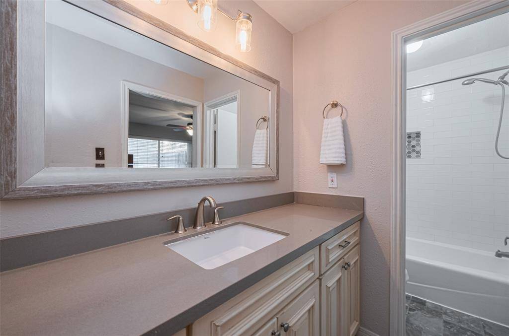 Quartz Counter tops, Large sink. Custom wood cabinets with large pull out drawers. Decorative Mirror. Freshly Painted.