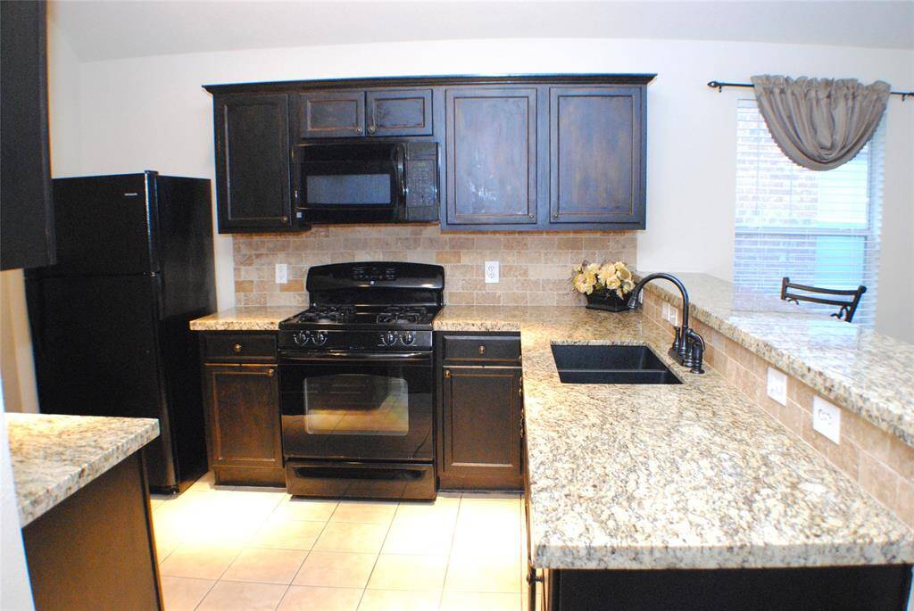 You'll love your gas range, gorgeous granite counters and warmly stained cabinets