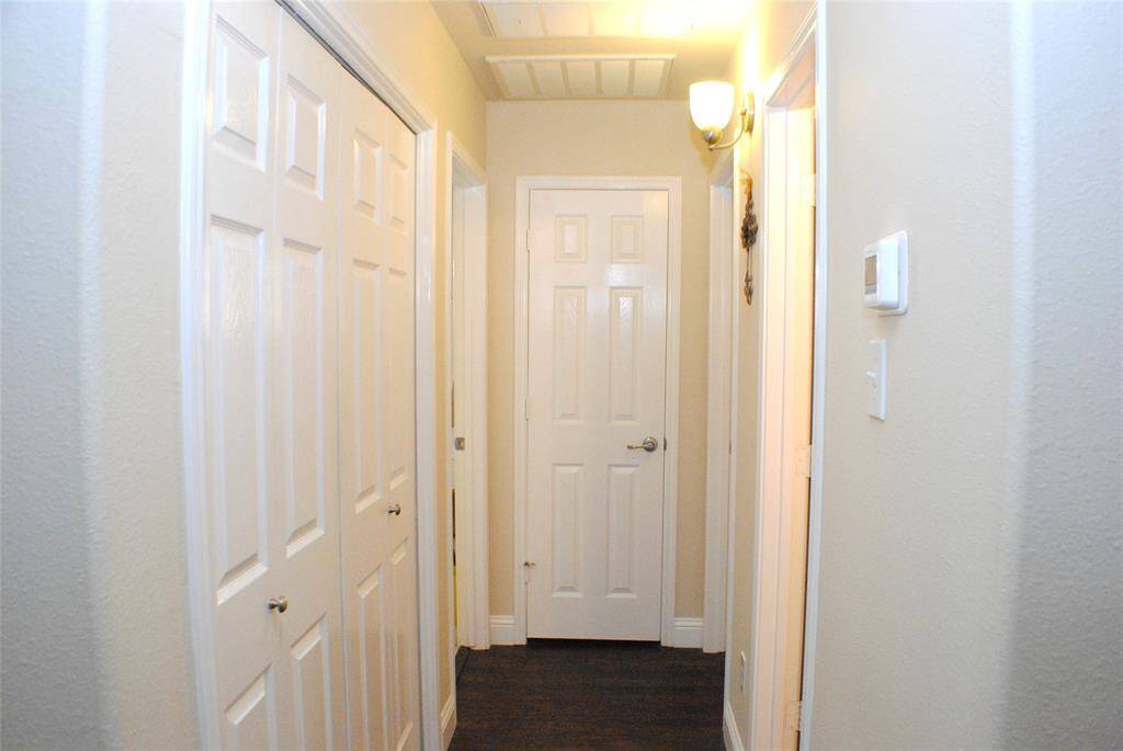Secondary bedroom hallway, with laundry (left) and a linen closet straight ahead