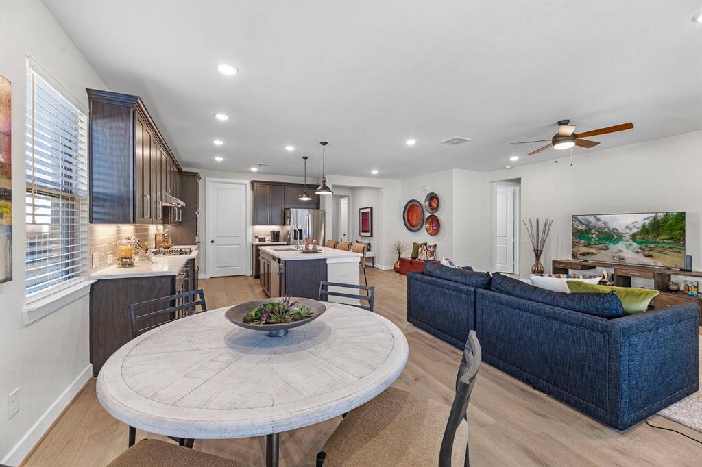 Spacious dining area with access to the backyard and covered patio area. Tons of natural light, neutral paint and wood floors.