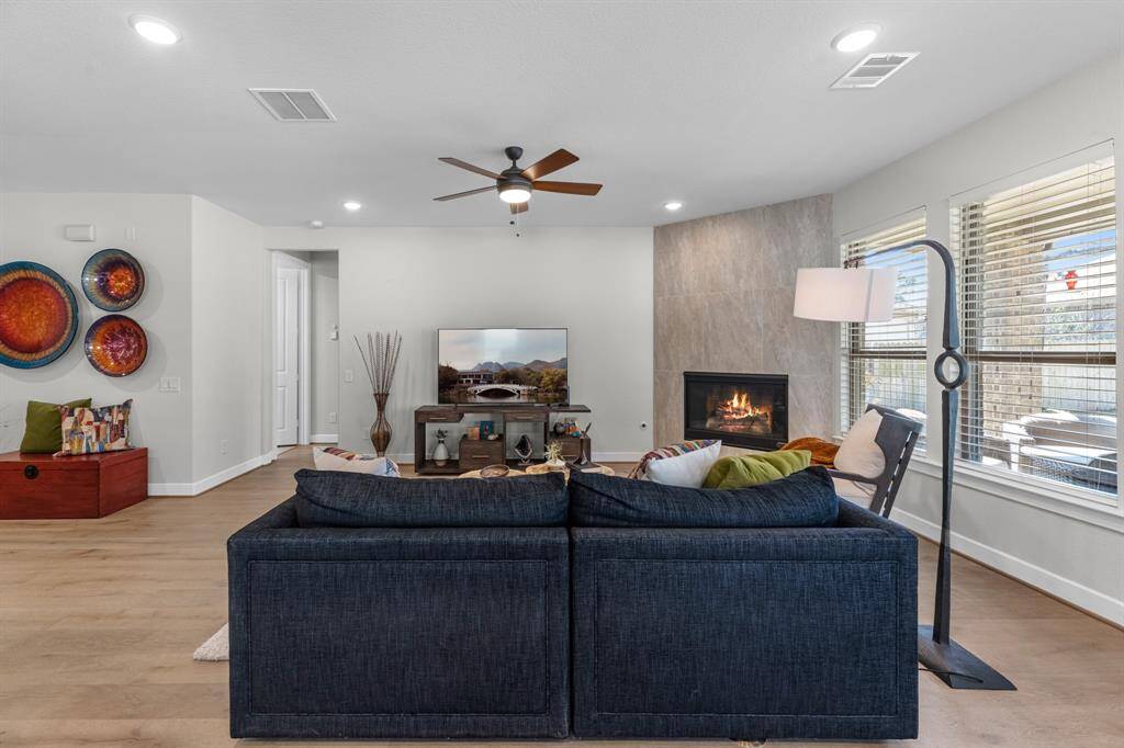 Great views to the back yard space with these floor to ceiling windows. This living area is spacious and has great connection to the kitchen and dining spaces