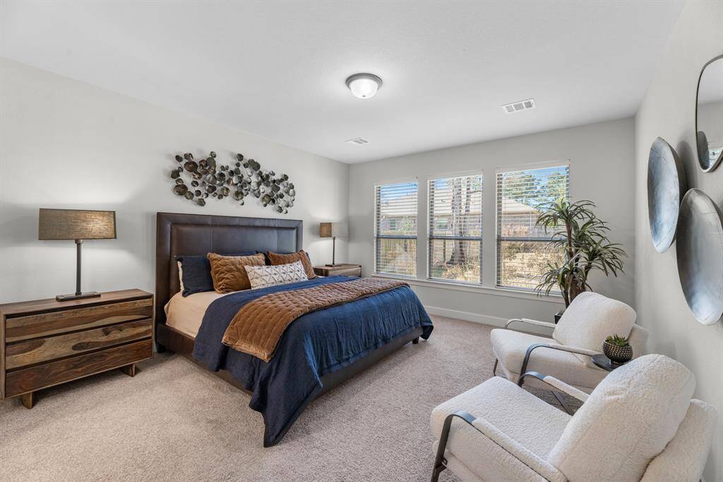 Main ensuite bath features expansive cabinet storage along with quartz counters and dual sinks. Spacious walk-in closet and walk-in shower enclosure-a true spa oasis.