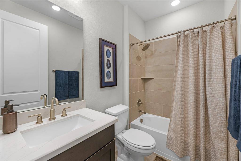 Spacious front bedroom with views of the front yard, offering tons of natural light throughout.