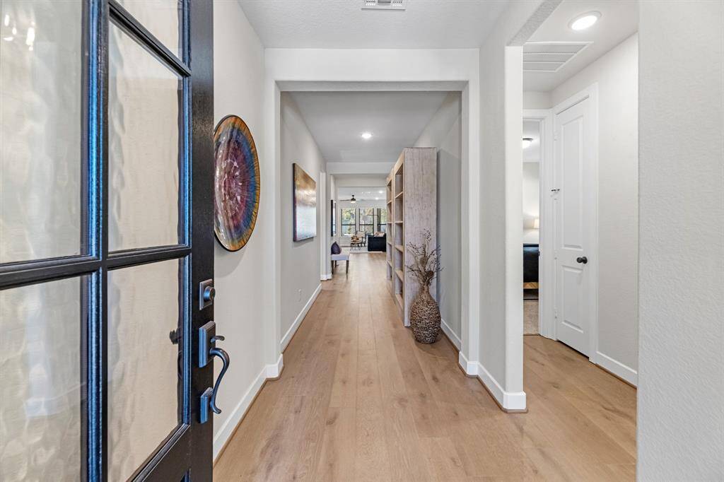 Living area featuring a corner fireplace with tiled surround, floor to ceiling windows and great open concept connection to both the kitchen and dining spaces.