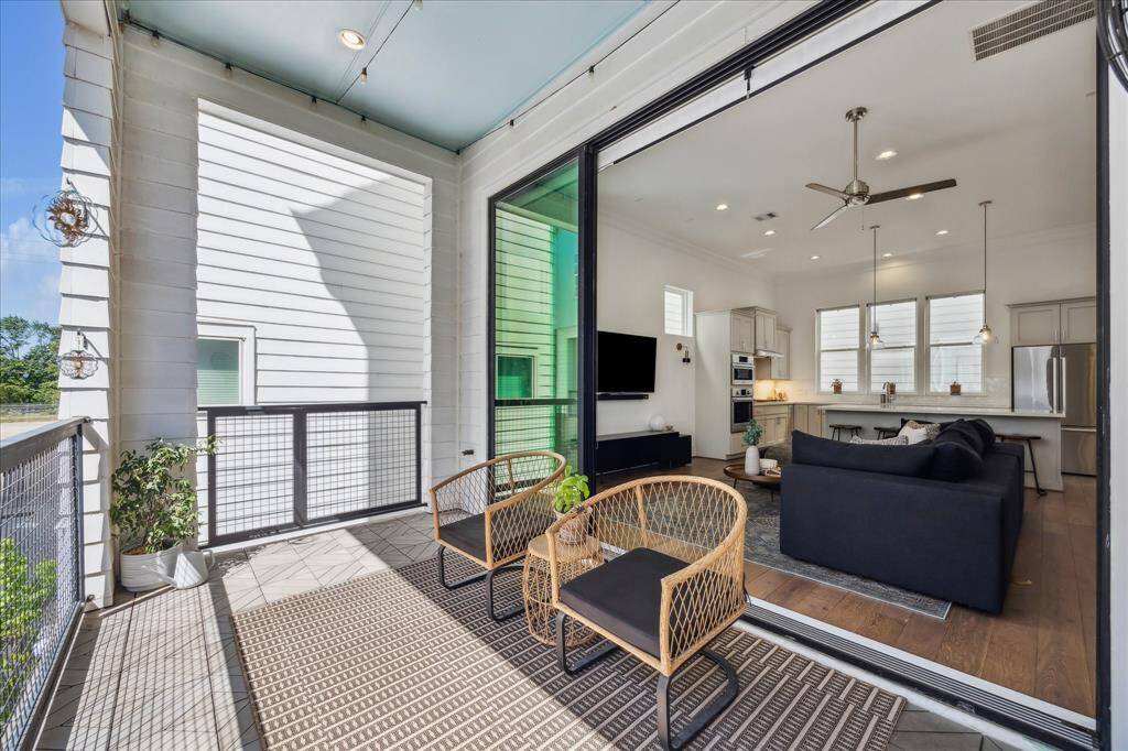 The family room opens to a private balcony, the perfect spot to savor your morning coffee or unwind after a long day. Expansive 10’ sliding glass doors welcome in natural light and create a seamless flow between indoor and outdoor living.