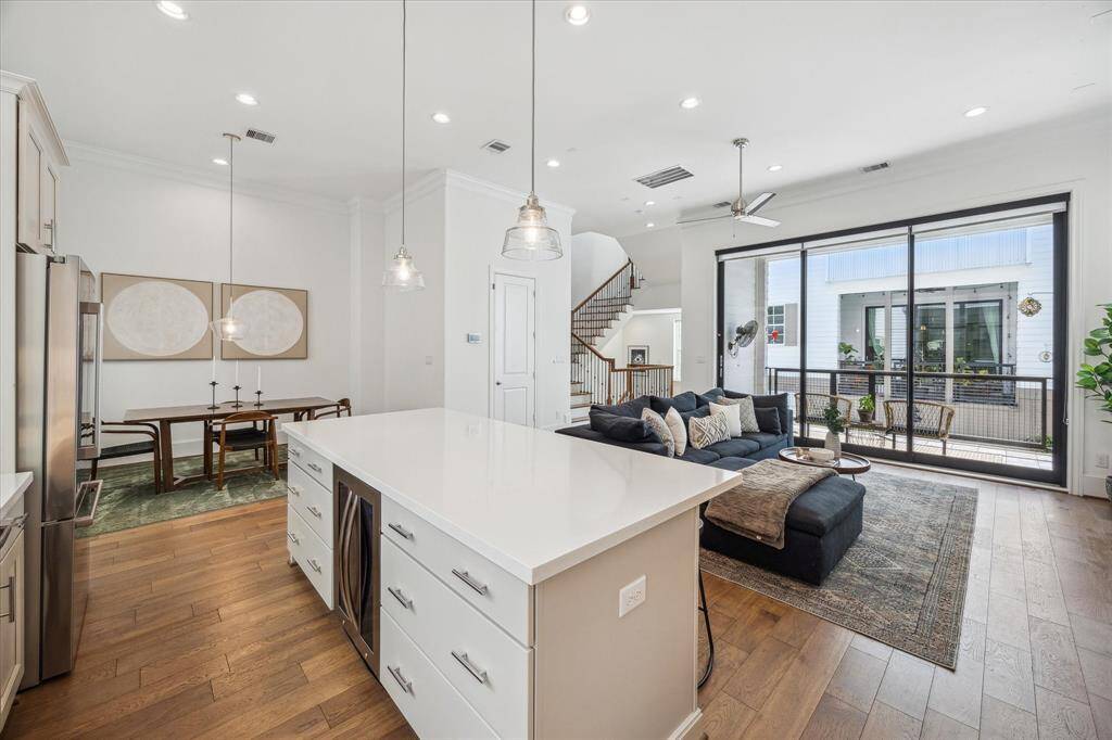 The heart of the kitchen is the impressive oversized island, perfectly designed for both function and flow. With sleek pendant lighting above and bar seating along one side, it's an ideal spot for chatting over coffee, grabbing a snack, or keeping the cook company during meal prep. The seamless connection to the dining area and family room makes entertaining feel effortless.