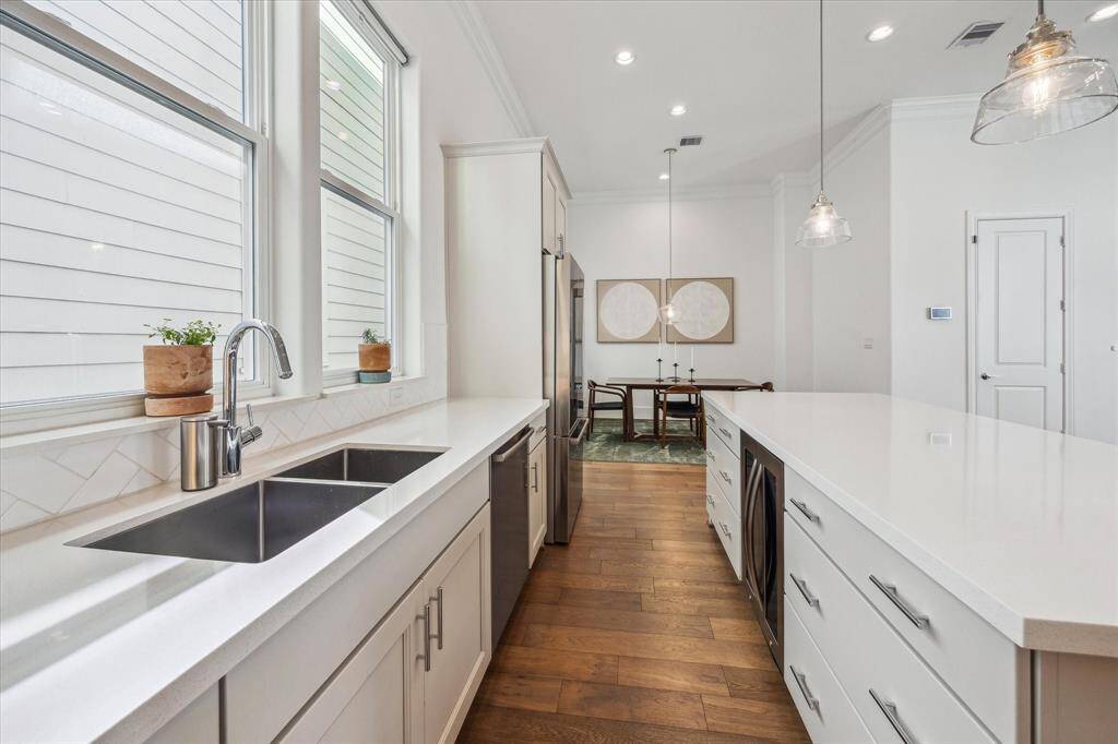 Ditch the takeout and fall in love with cooking all over again! This sleek island kitchen is a chef’s dream, featuring Quartz countertops, subway tile backsplash, stainless steel appliances including a beverage chiller, upgraded sinks with a pull-down fixture, and plenty of space for your sous chef and cleanup crew.