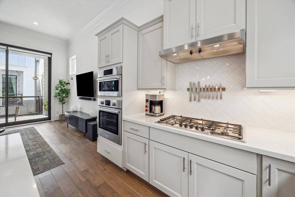 Whether you're a seasoned chef or a snack-time pro, this kitchen has you covered with a full suite of stainless steel appliances, including a gas cooktop, built-in electric oven, microwave, dishwasher, French door refrigerator, and a convenient beverage chiller.