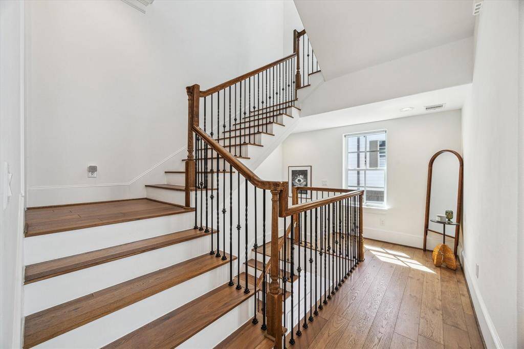 Throughout the home, designer finishes and elegant touches create an atmosphere of modern elegance and timeless charm. Enjoy engineered wood flooring, a fresh neutral color palette, ornate iron spindles with rich wood railings along the staircase, oversized windows that invite in natural light, and chic lighting set in soaring ceilings.