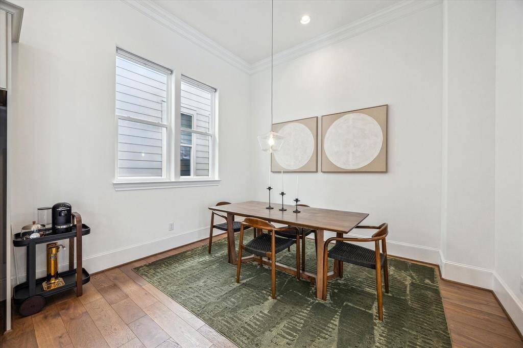 Gather them around your table to honor old traditions and create the new. This elegant dining area with chic lighting and gorgeous engineered wood flooring opens to the kitchen and family room for an effortless flow that’s perfect for entertaining and everyday living.