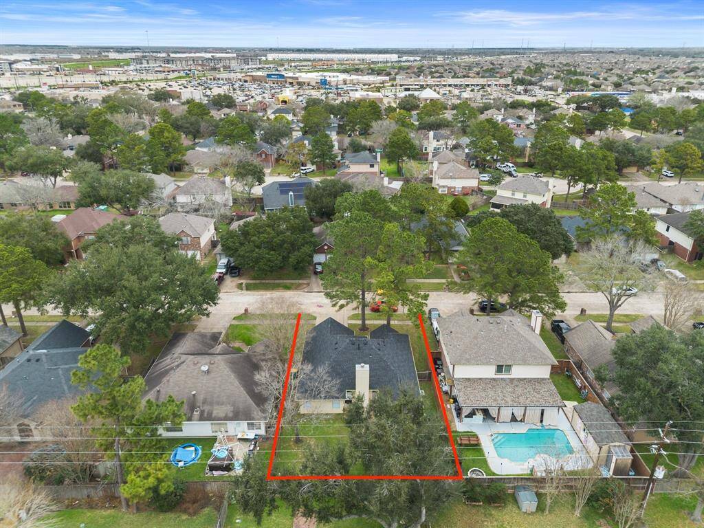 Enjoy a breathtaking aerial view of the back of the home, highlighting its spacious yard and inviting outdoor space.