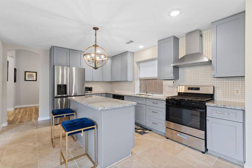 The kitchen is a chef’s dream, featuring custom painted cabinets, sleek granite countertops, a spacious kitchen island, and recessed lighting that beautifully illuminates the space.