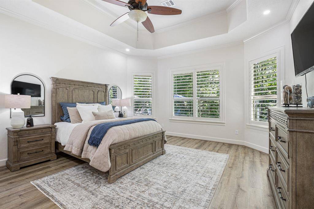 Fabulous primary bedroom has high ceilings, amazing views of the backyard, and a private en suite.