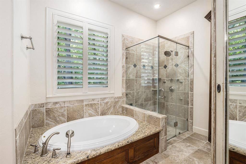 This primary bathroom also has a relaxing soaking tub, and a glass-standing shower.