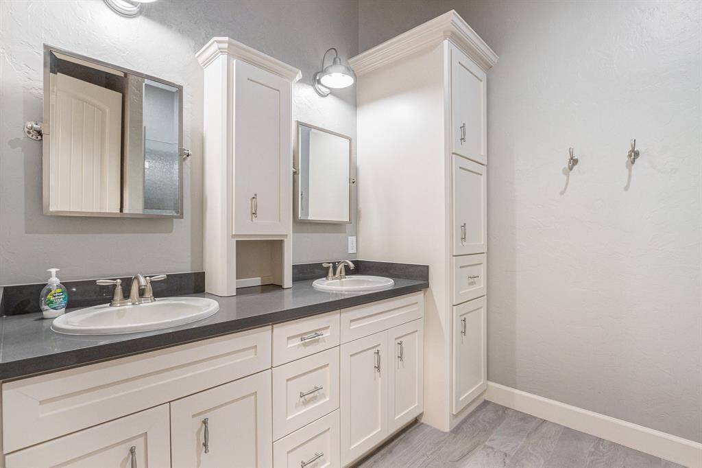 Amazing secondary bathroom with lots of storage, dual sinks, and a combination tub and shower.