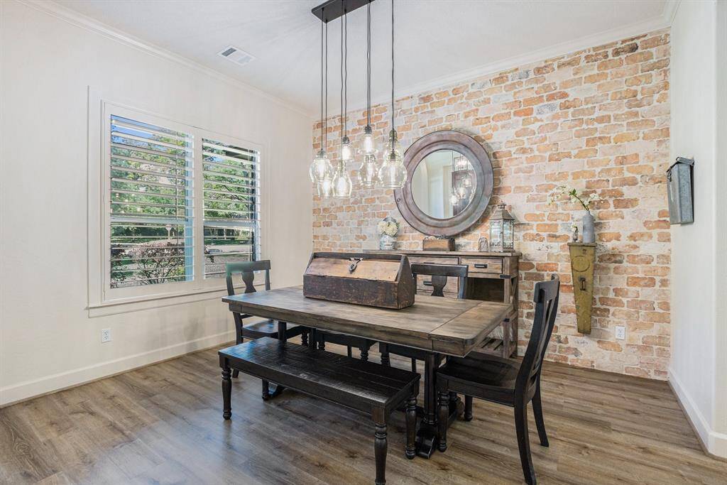 Charming formal dining room off the kitchen with great views of the front yard.