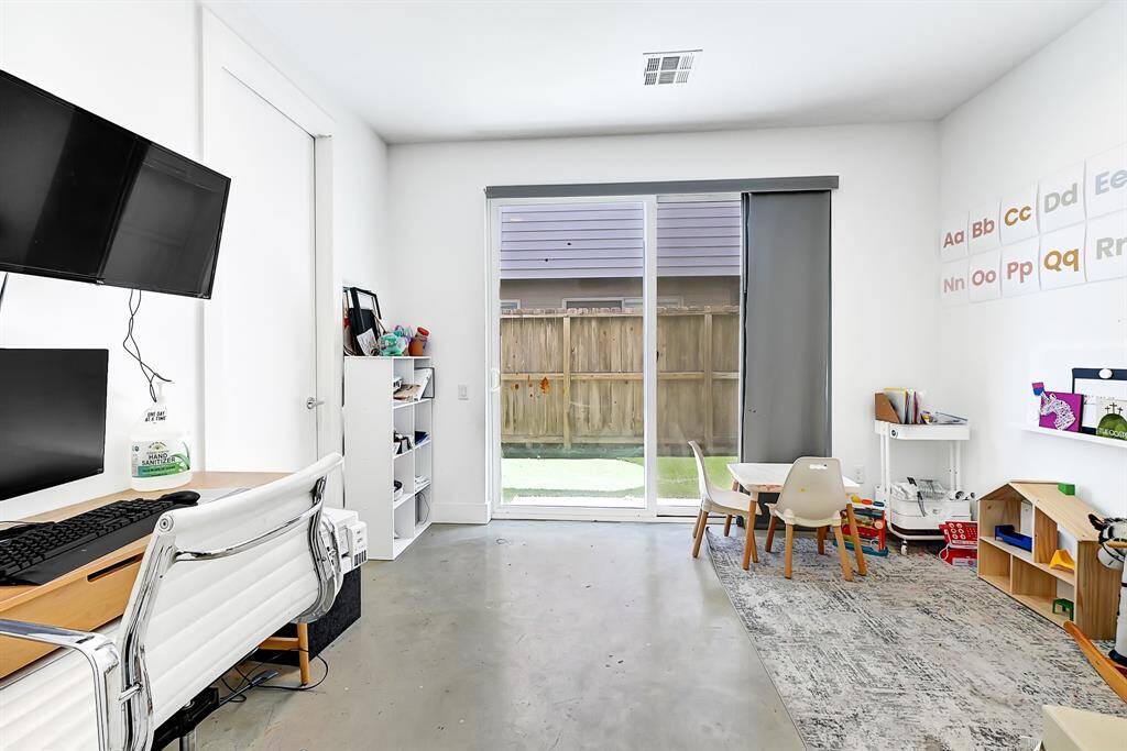 The first downstairs bedroom, complete with a private bathroom, which leads to the outdoor turf area.
