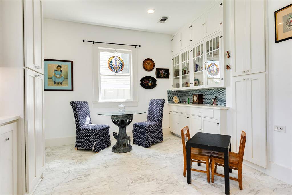 Nice breakfast/informal dining space in the kitchen. Note built it cabinets for additional pantry and decor display.