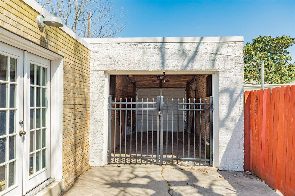 View into attached garage with rear automatic garage door.