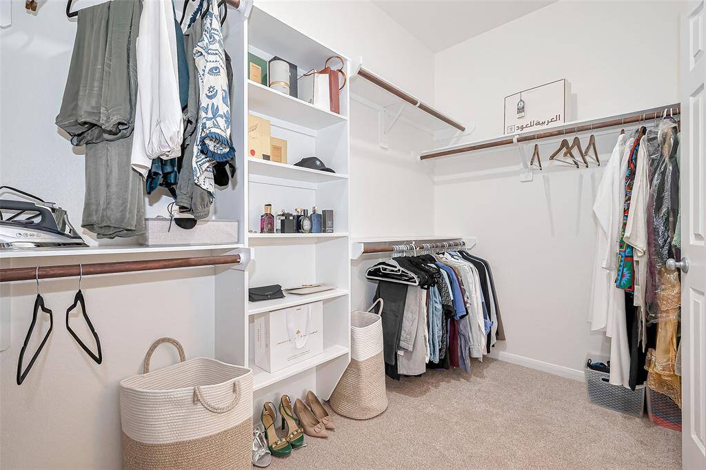 Experience the epitome of comfort and convenience in this meticulously crafted walk-in closet. You will have enough space to store your belongings.