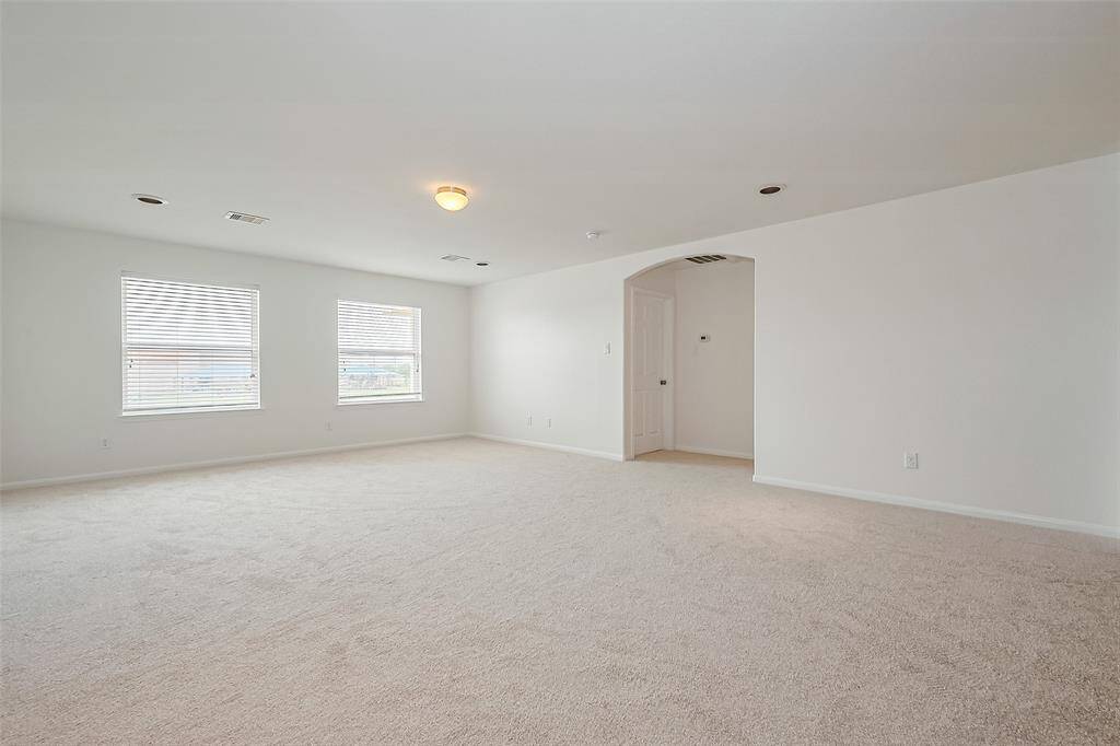 Natural light floods through the windows, creating a bright and airy atmosphere, while neutral tones provide a serene backdrop for relaxation.