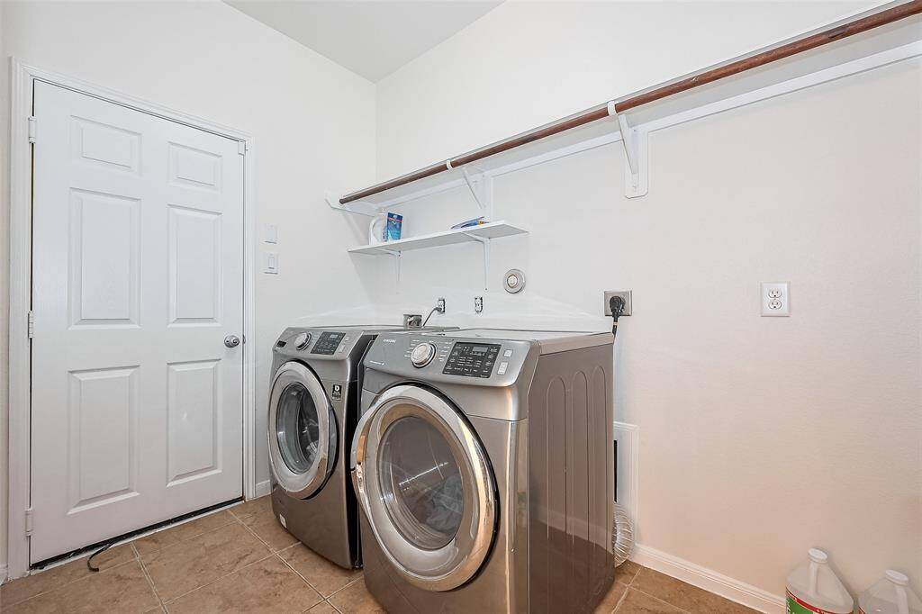 Upon entering the laundry room, you're greeted by a bright and inviting atmosphere that makes household chores feel like a breeze.