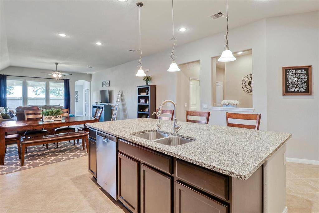 The open-concept layout seamlessly connects the kitchen to the dining and living areas, offering an ideal setup for entertaining or everyday living in style.