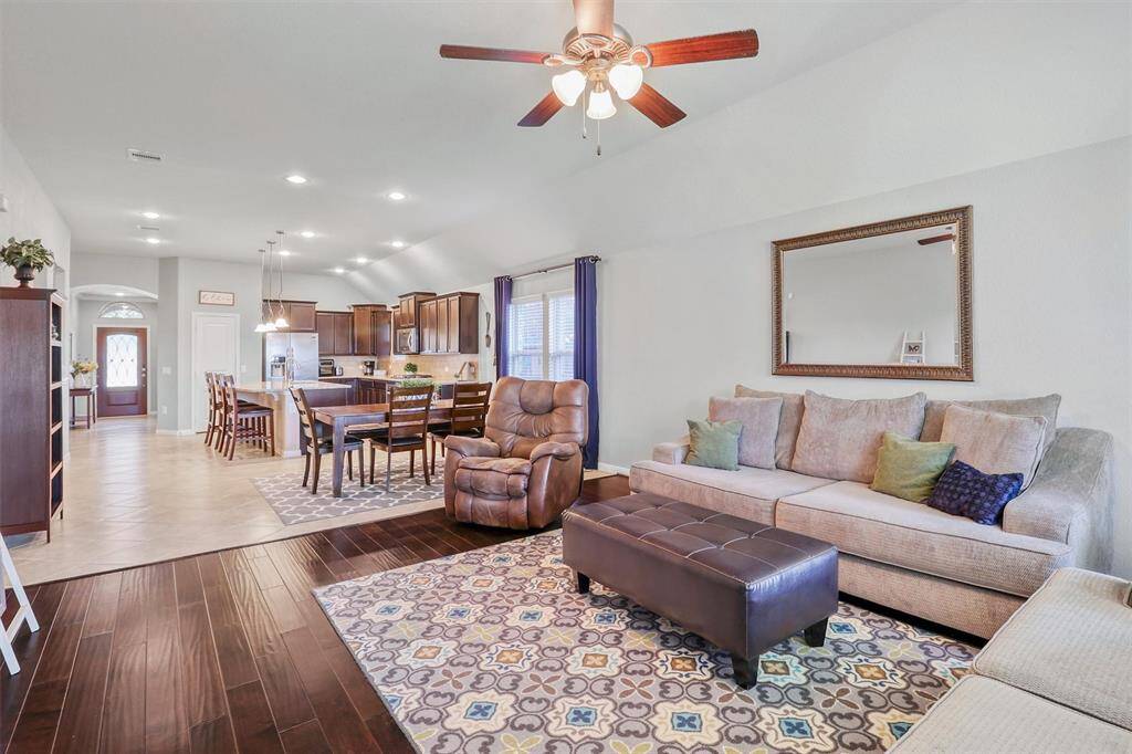 This inviting family room flows effortlessly from the dining and kitchen areas, offering plenty of room for oversized seating, media setup, and cherished moments with family and friends.