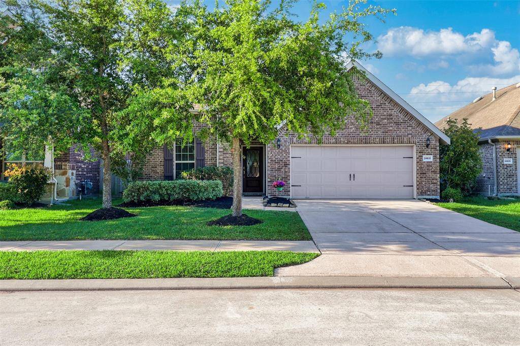 A daylight view of this stunning 3-bedroom, 2-bath residence shows off the lush landscaping and oversized driveway leading to a 2-car garage—an ideal setting just minutes from Olde Town Katy and zoned to top-rated Katy ISD schools.