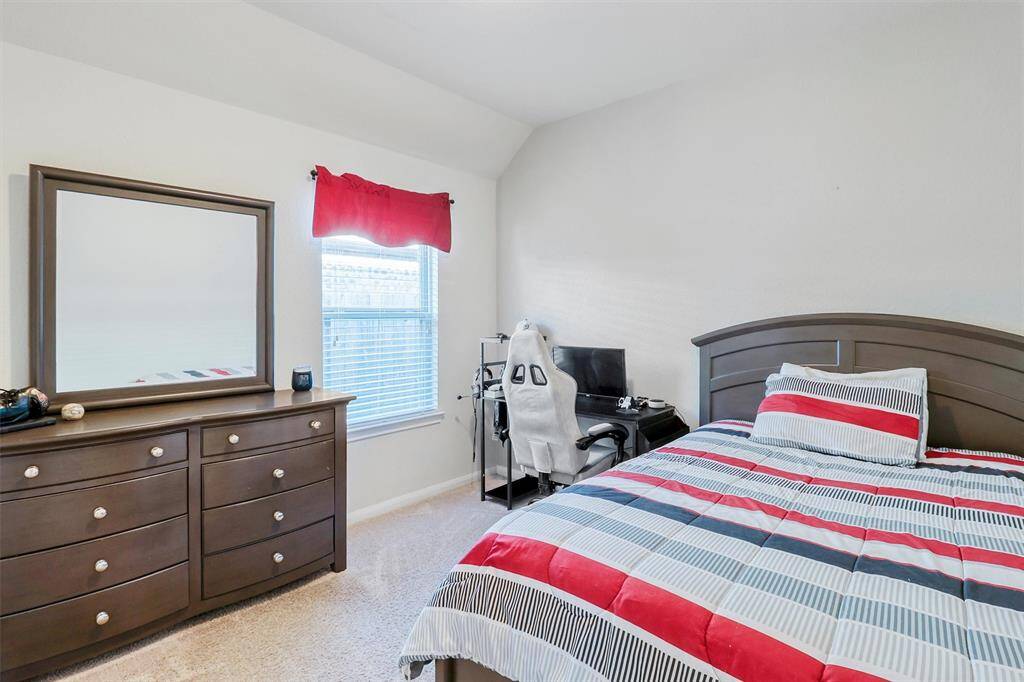Enjoy the convenience of a roomy double-door closet and easy hallway access in this inviting bedroom. Whether used as a guest room or personal sanctuary, the clean lines and cozy finishes create a calm and comfortable atmosphere.