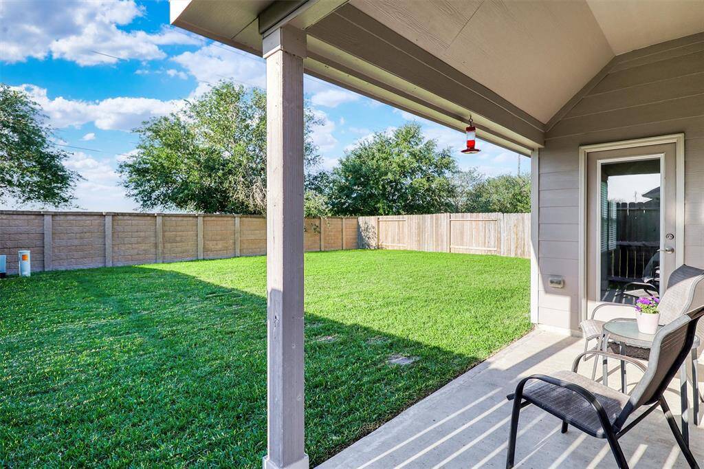 Enjoy morning coffee or evening breezes from the comfort of your covered back patio, perfectly shaded and overlooking the lush backyard.