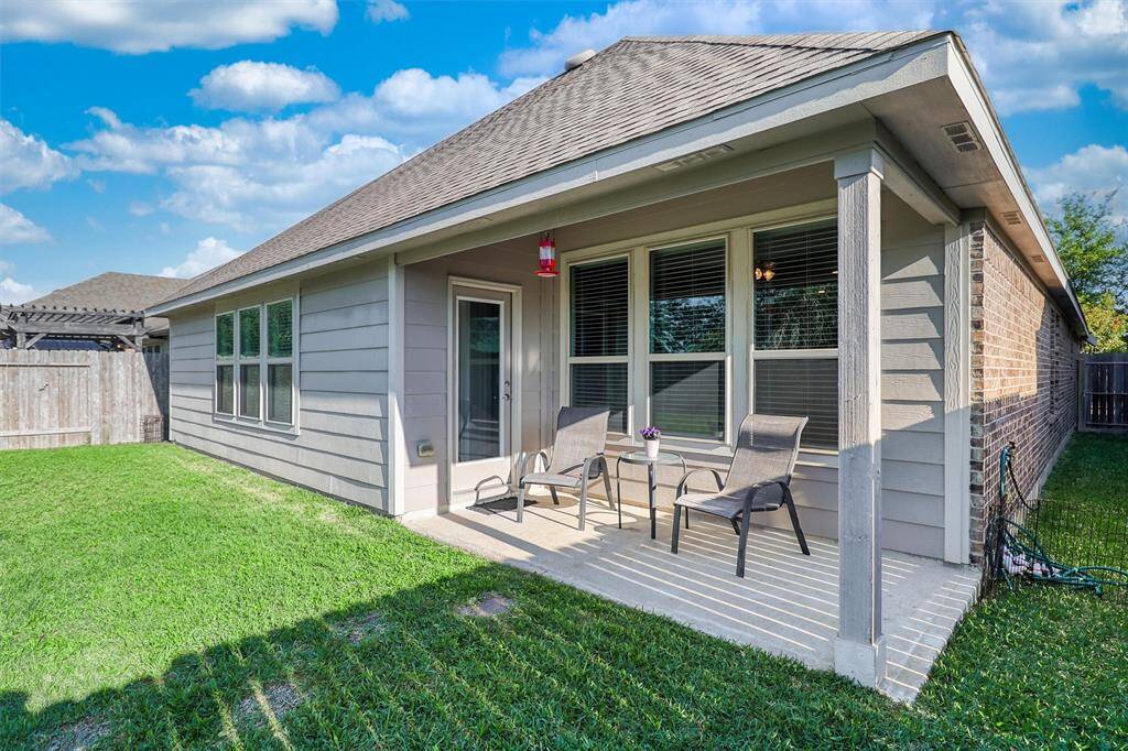 The covered patio offers plenty of space for shaded relaxation, while the fully fenced backyard creates a private retreat for unwinding or entertaining.