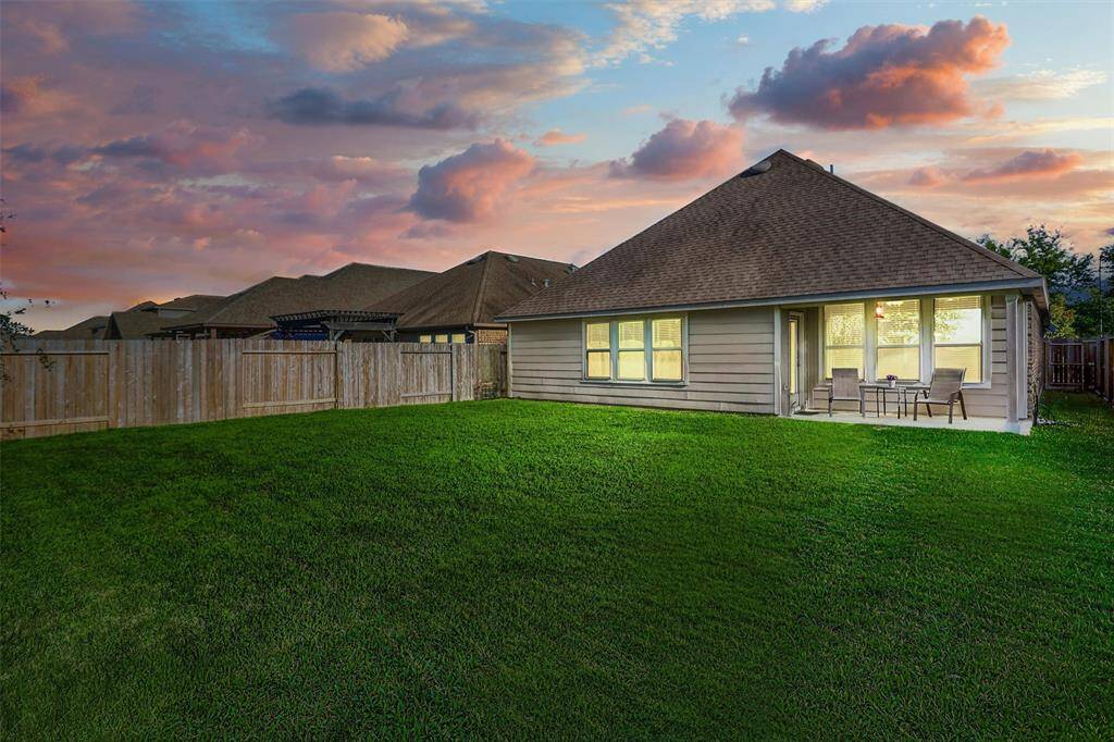 As the sun sets, the backyard transforms into a peaceful sanctuary—perfect for winding down the day under colorful Texas skies.