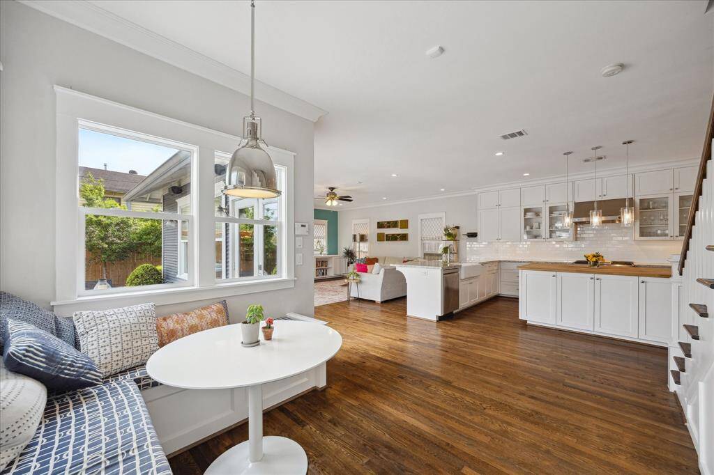 Just off the covered carport, step into a bright and open breakfast nook that flows effortlessly into the kitchen and living areas — a cozy spot to enjoy coffee with a view of the backyard.
