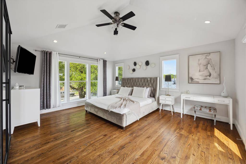 A serene retreat with modern elegance—this primary suite boasts expansive proportions, a custom accent wall, and abundant space for a sitting area, workspace, or reading nook.
