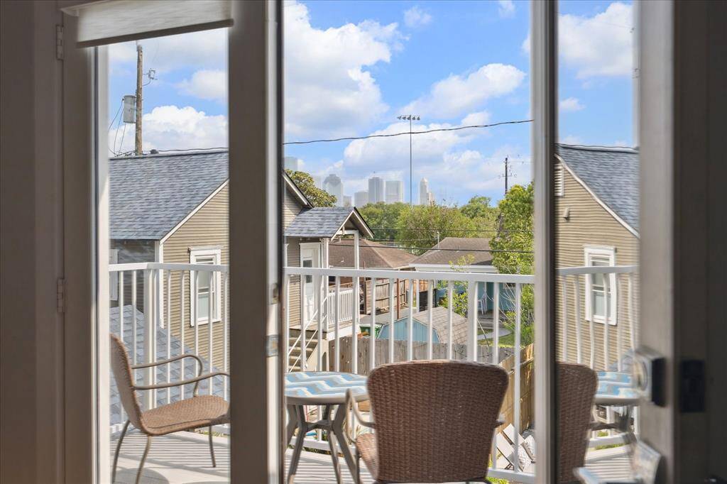 Step out from the primary bedroom onto your private balcony — the perfect spot to unwind with a morning coffee or evening glass of wine while enjoying treetop views of the neighborhood and a peek at downtown.
